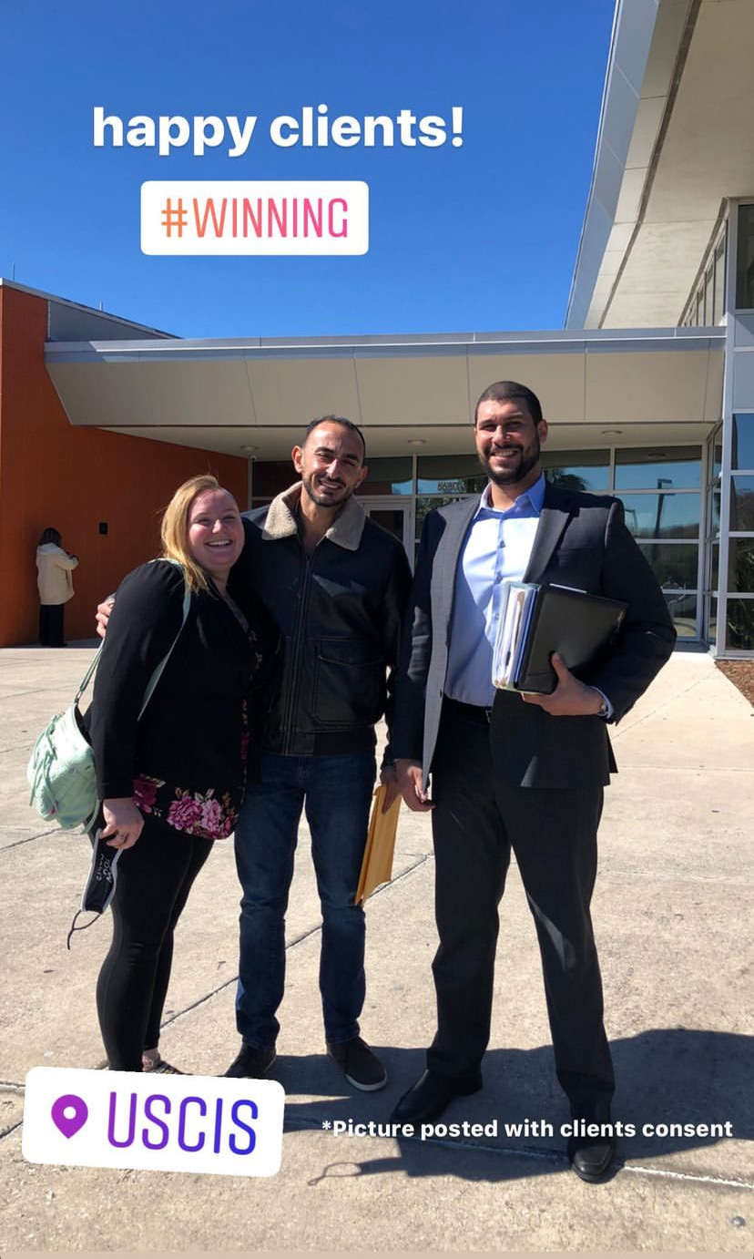 Yazen Abiiden standing with clients outside USCIS