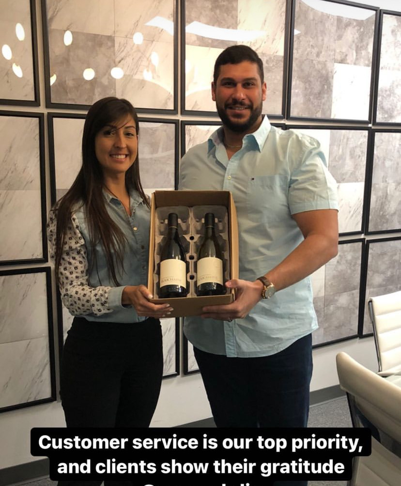 Yazen Abiiden and a client holding a gift of appreciation